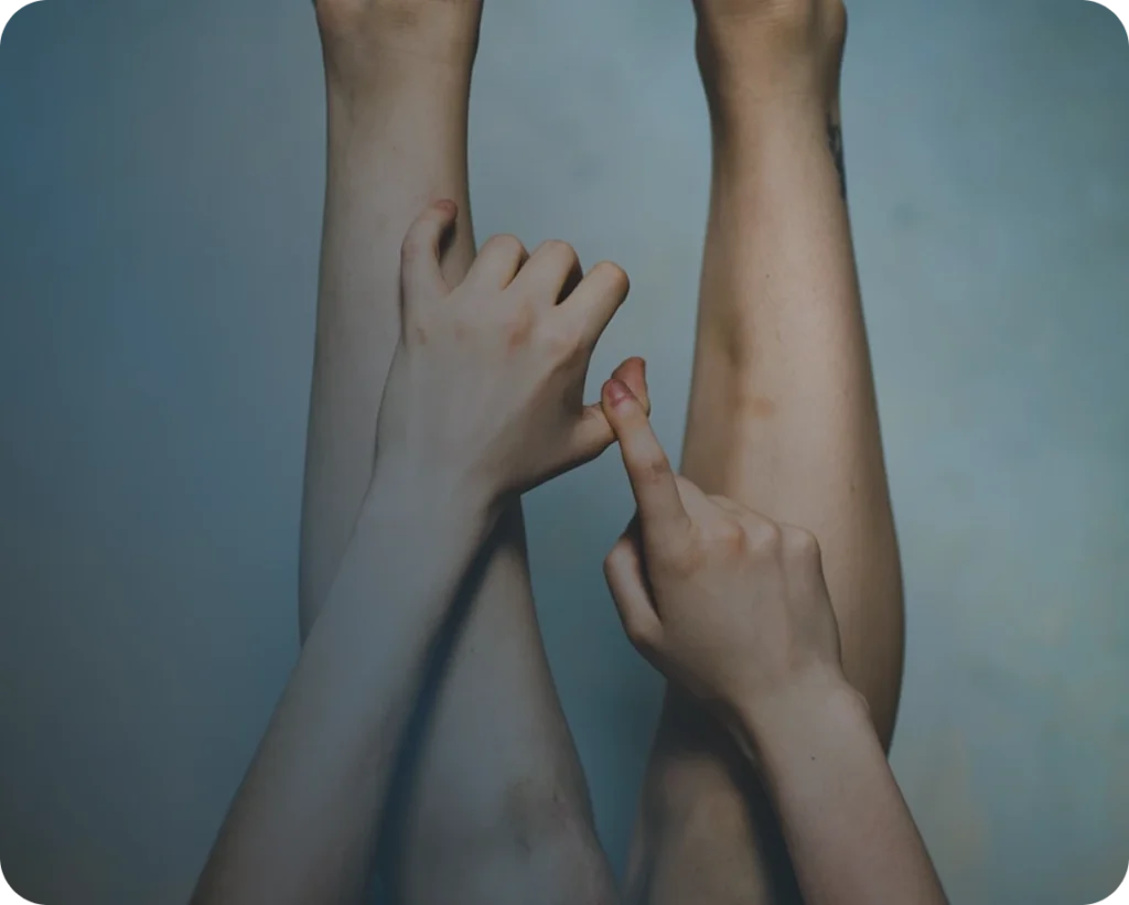 Hands over legs close up